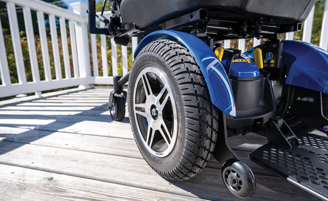 closeup view of the drive wheel on a blue power wheelchair