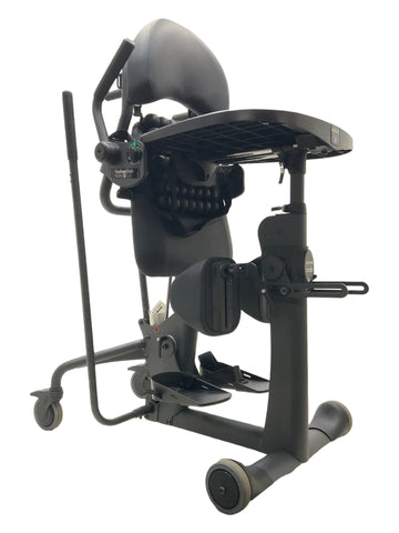 a black sit-to-stand standing frame with a black cushions and activity tray