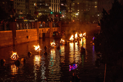 braziers with lit bonfires burn atop the Providence River