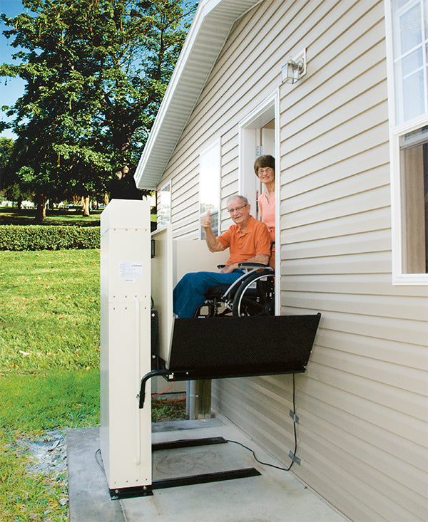 elderly couple using vertical platform lift