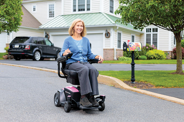 woman riding a power wheelchair on the street