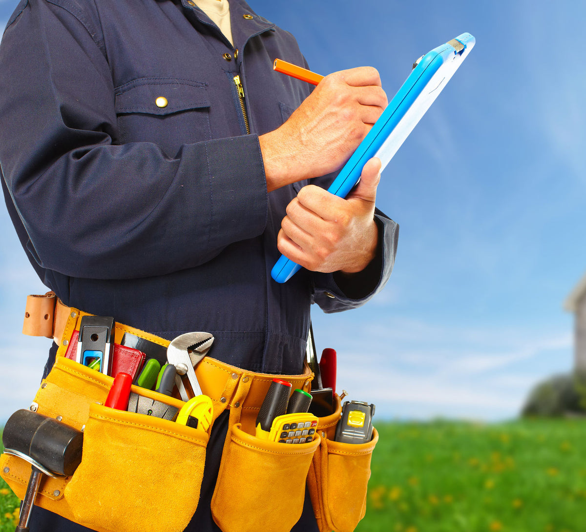 construction man outside with tool belt writing on a pad