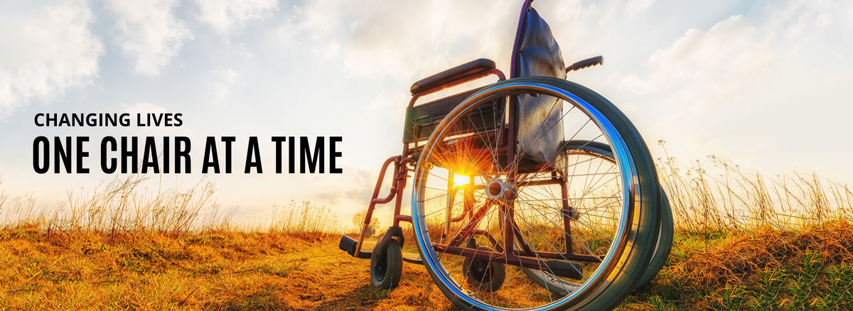 wheelchair sitting on a field with a sunset