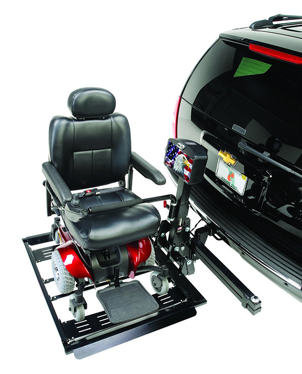 a red power chair is stowed on a hitch lift on the back of a black vehicle against a white background