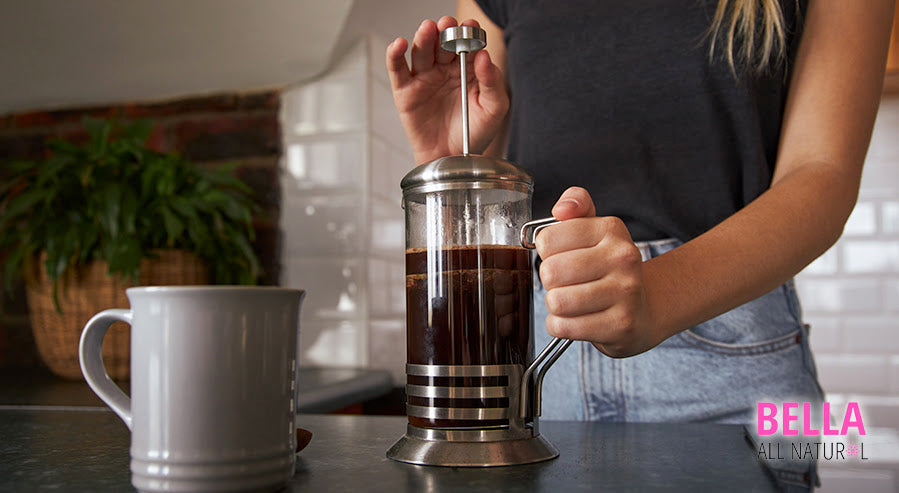 A Person Making French Press Coffee