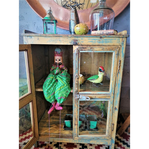 Green and yellow colour display in glass cabinet