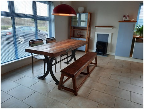 Farmhouse table with 3 seats and a bench in a kitchen interior