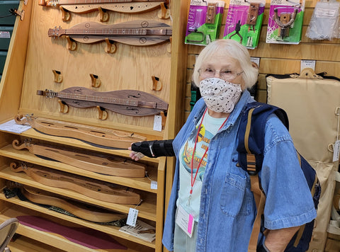 masked KMW 2022 attendee in folkcraft display