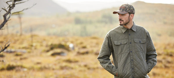 Man wearing Ridgeline clothing in a countryside setting