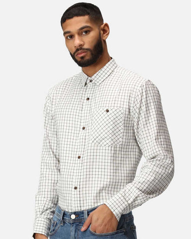 Man wearing Regatta Tattersall Check Shirt with jeans against a white background