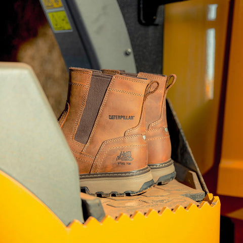 Caterpillar Pelton S1P Safety Boots against a machinery background