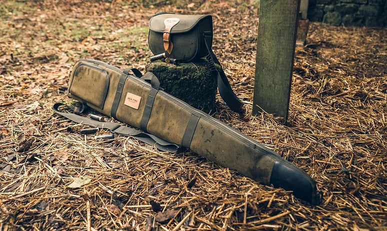 Jack Pyke gun slip and cartridge bag against a grassy hay background