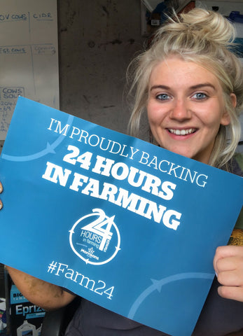 Anna holding a sign that states she backs 24 hour farming