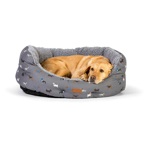 Dog curled up in Danish Design Fatface Marching Dogs Deluxe Slumber Bed against a white background