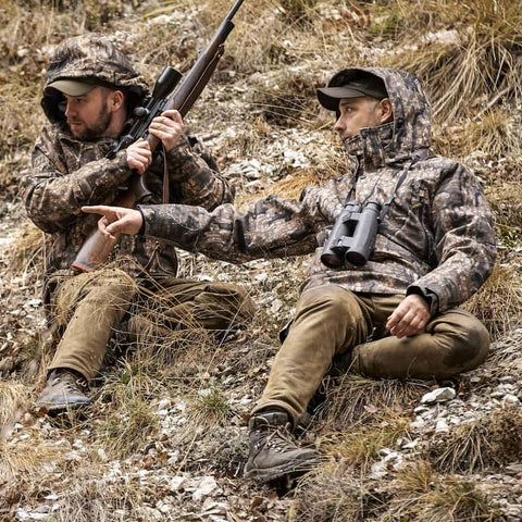 Two men wearing Deerhunter clothing in camo for hunting in the fields