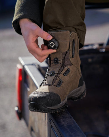 Person reaching to adjust laces on Harkila Reidmar Mid 2.0 GTX Leather Boots in willow green