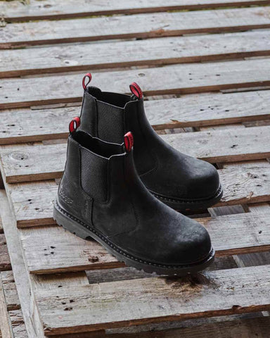 Hoggs of Fife Zeus Safety Dealer Boots in black on a wooden pallet outdoors