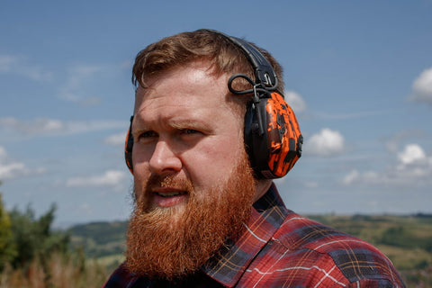 Man wearing Peltor ear defenders outdoors