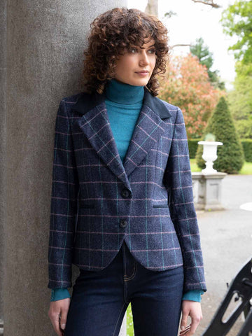Woman wearing tweed blazer with a roll neck sweater and jeans
