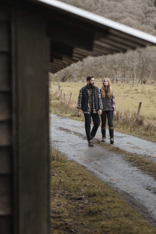 Man and woman walking together in the countryside, both wearing Hoggs of Fife Boots