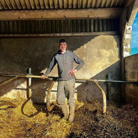 Man wearing Swazi The Hood in Black standing in a hay barn