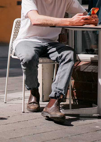 Man Sitting Down Outside Wearing Blundstone 550 Boots