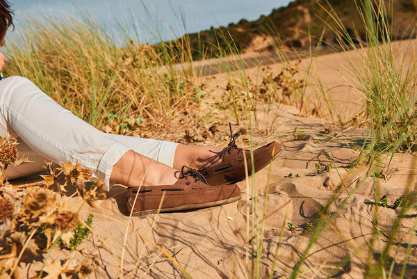 The Dubarry Aruba Deck Shoes being worn by someone lounging on a beach