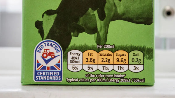 A close up of a Red Tractor label on a milk carton.