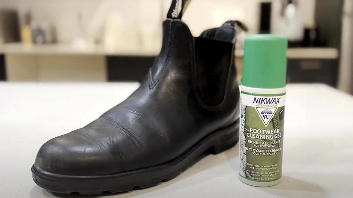Nikwax Footwear Cleaning Gel next to a leather boot on a white surface