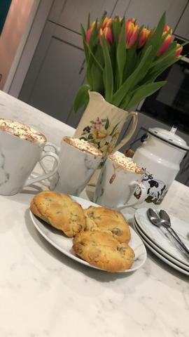 Dining table - 3 cups of hot chocolate, biscuits, and a vase of flowers