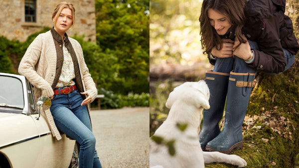 Woman wearing knitwear resting against a car and woman wearing wellies bending down to pet dog