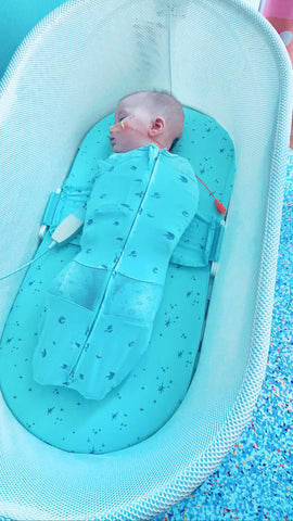 Baby sleeping in SNOO bassinet after open-heart surgery