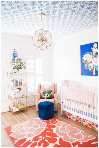Nursery decorated in shades of blue, red, and turquoise