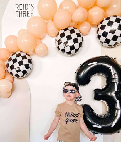 Race car-themed third birthday party balloons and decorations