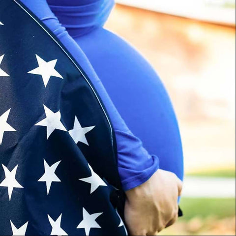 Baby bump decked out with an American flag for a 4th of July pregnancy announcement