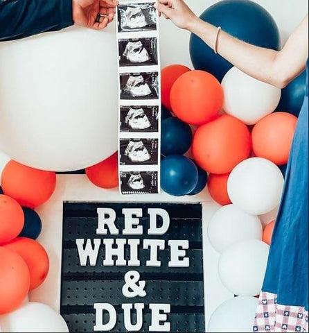 4th of July pregnancy announcement featuring red, white, and blue balloons