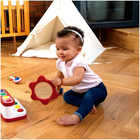 6-month-old baby playing with a mirror toy