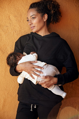Rachel Nicks, founder of Birth Queen, breastfeeds her son