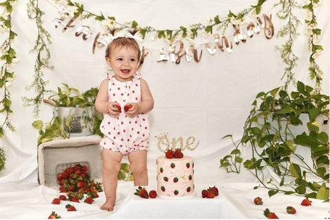 Baby and smash cake decorated with strawberries.