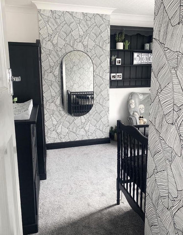 Black nursery with patterned wallpaper