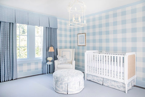 Baby nursery with pale blue checkered wallpaper.