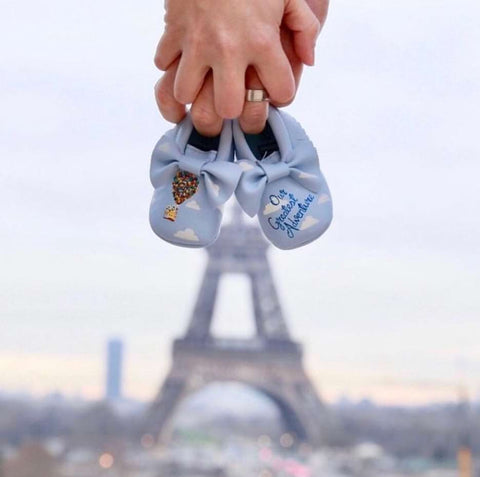 Disney pregnancy announcement photo: A pair of baby shoes that are embroidered with the house from "Up" and the words "Our Greatest Adventure"