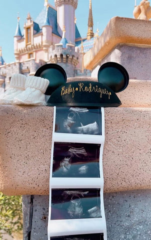 A Disney pregnancy announcement with a pair of Mickey ears an sonogram