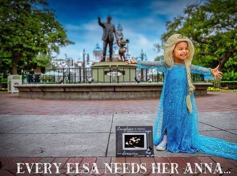 Disney pregnancy announcement photo: A little girl dressed as Elsa from Frozen poses next to a sonogram photo, beneath her text reads: Every Elsa Needs Her Anna