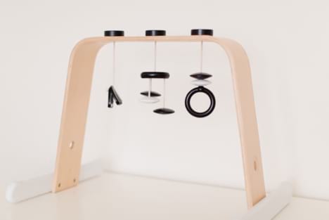 DIY play gym with black and white attachments