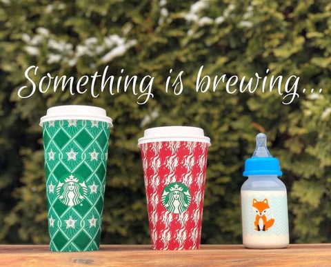 DIY pregnancy announcement photo of two Starbucks coffee cups lined up next to a baby bottle