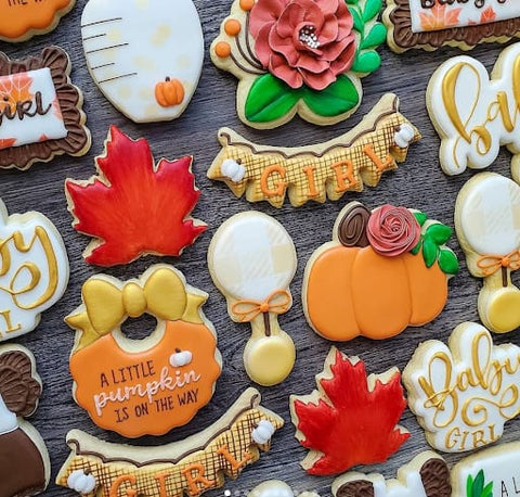 Colorful leaf and pumpkin cookies for a fall baby shower