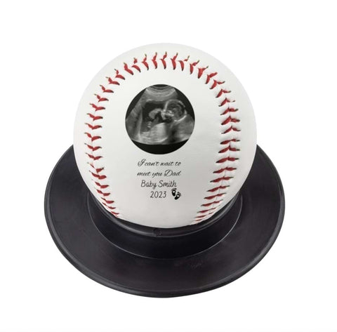 An ultrasound printed on a baseball for a Father's Day pregnancy announcement