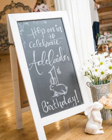 Decorative chalkboard that says "Hop in to celebrate Adelaide's 1st birthday!"