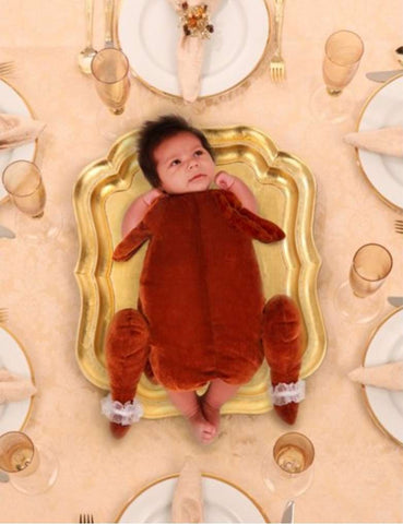 Baby dressed as a turkey for their first Thanksgiving